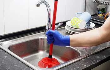 Removing blockage of the pipe, drain in the sink with a plunger